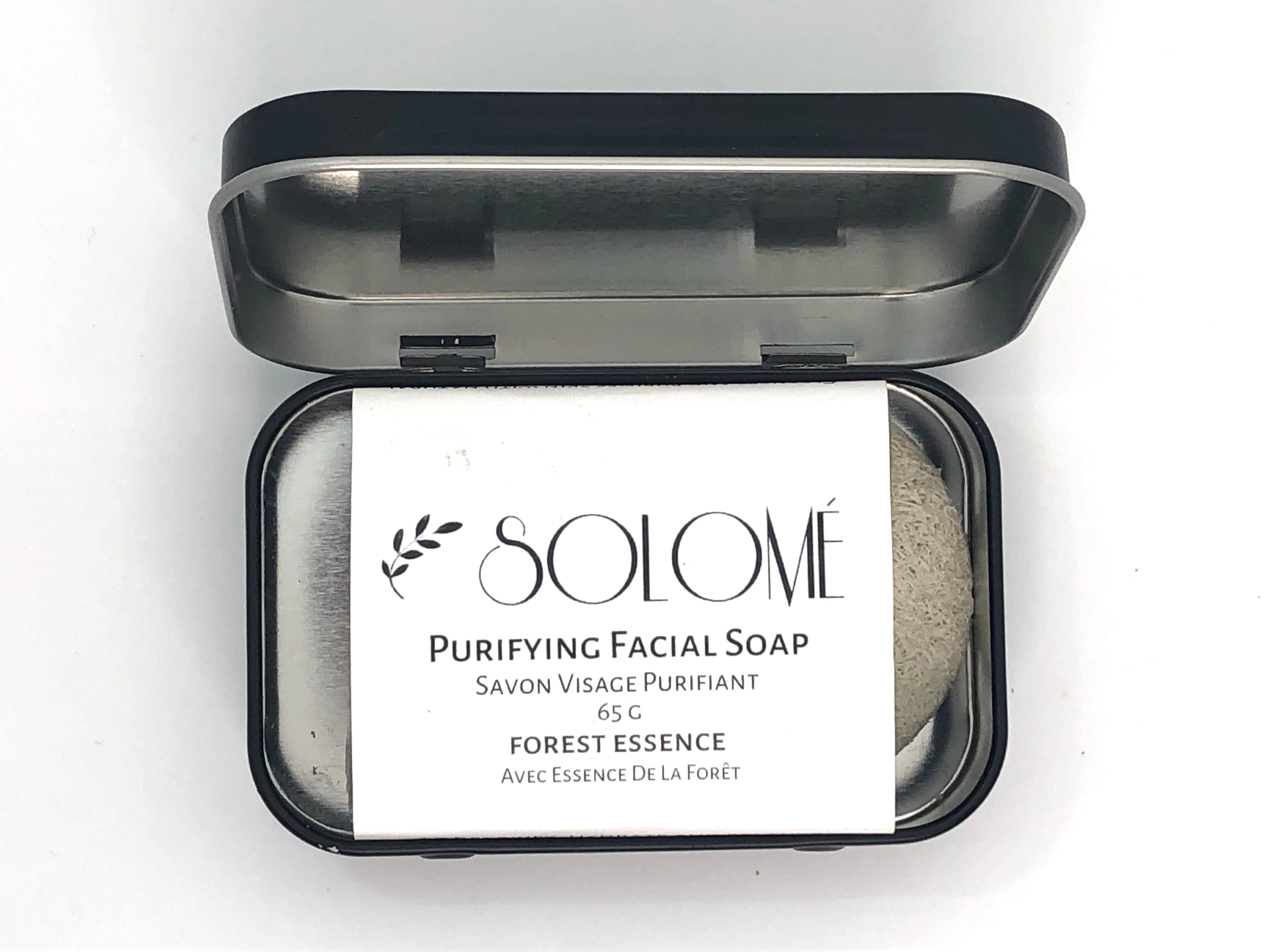 Purifying face soap bar with essential oils, perfect for acne-prone and sensitive skin in travel case