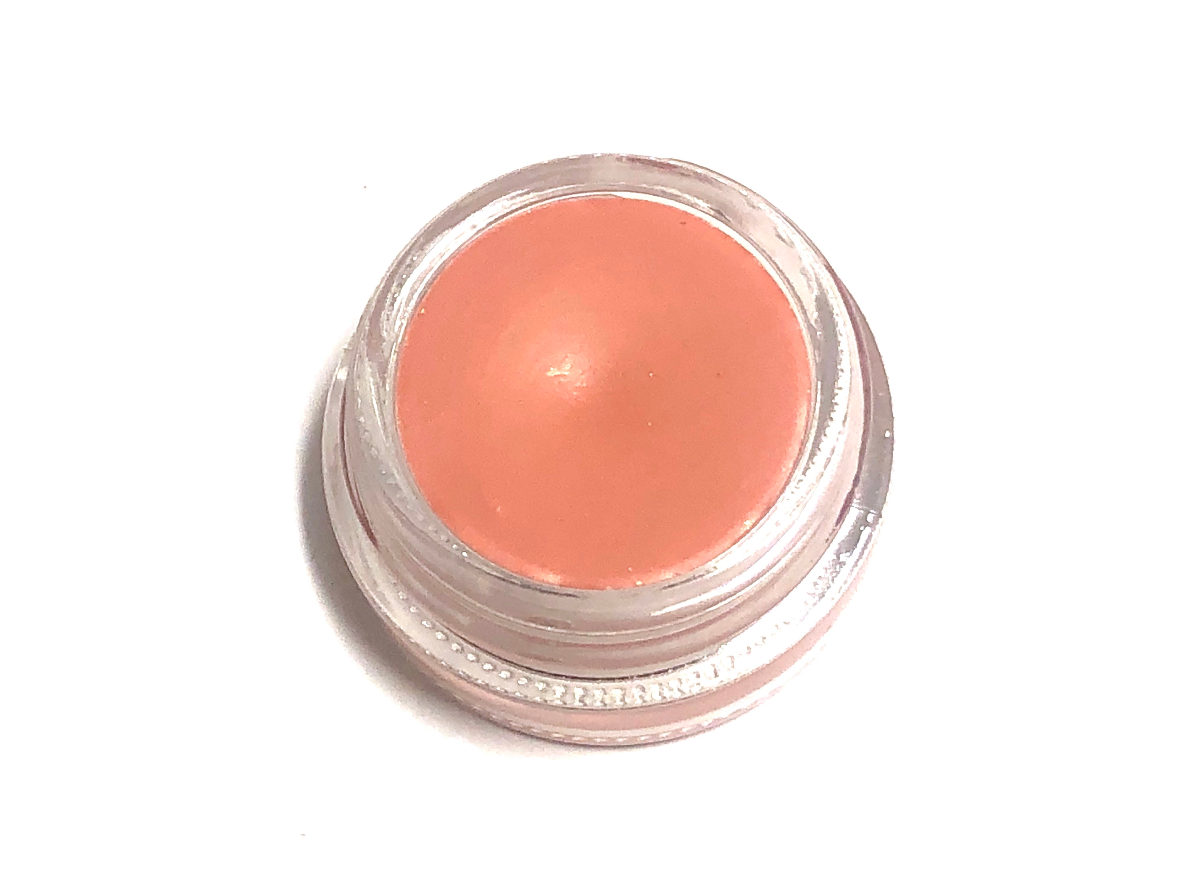 Solomé Beauty’s Lip & Cheek Tint in Coral, housed in a minimalist glass jar, delivering a warm, peachy glow for lips and cheeks.